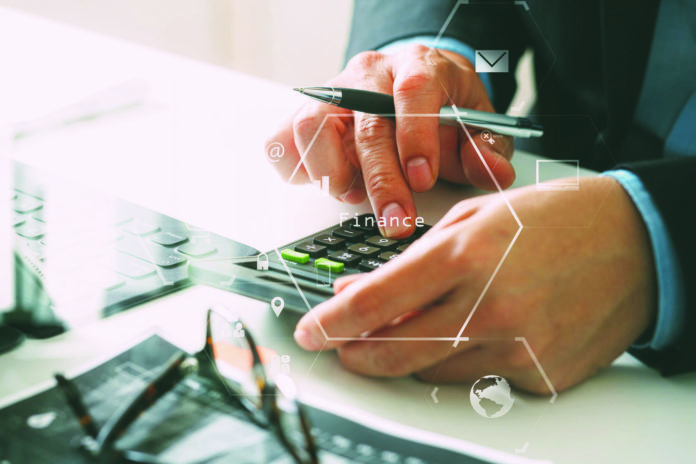 close up of businessman hand working with finances about cost an