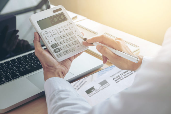 Female accountant calculations and analyzing financial graph dat