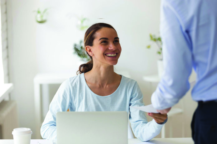 Smiling biracial manager satisfied with cash bonus reward.